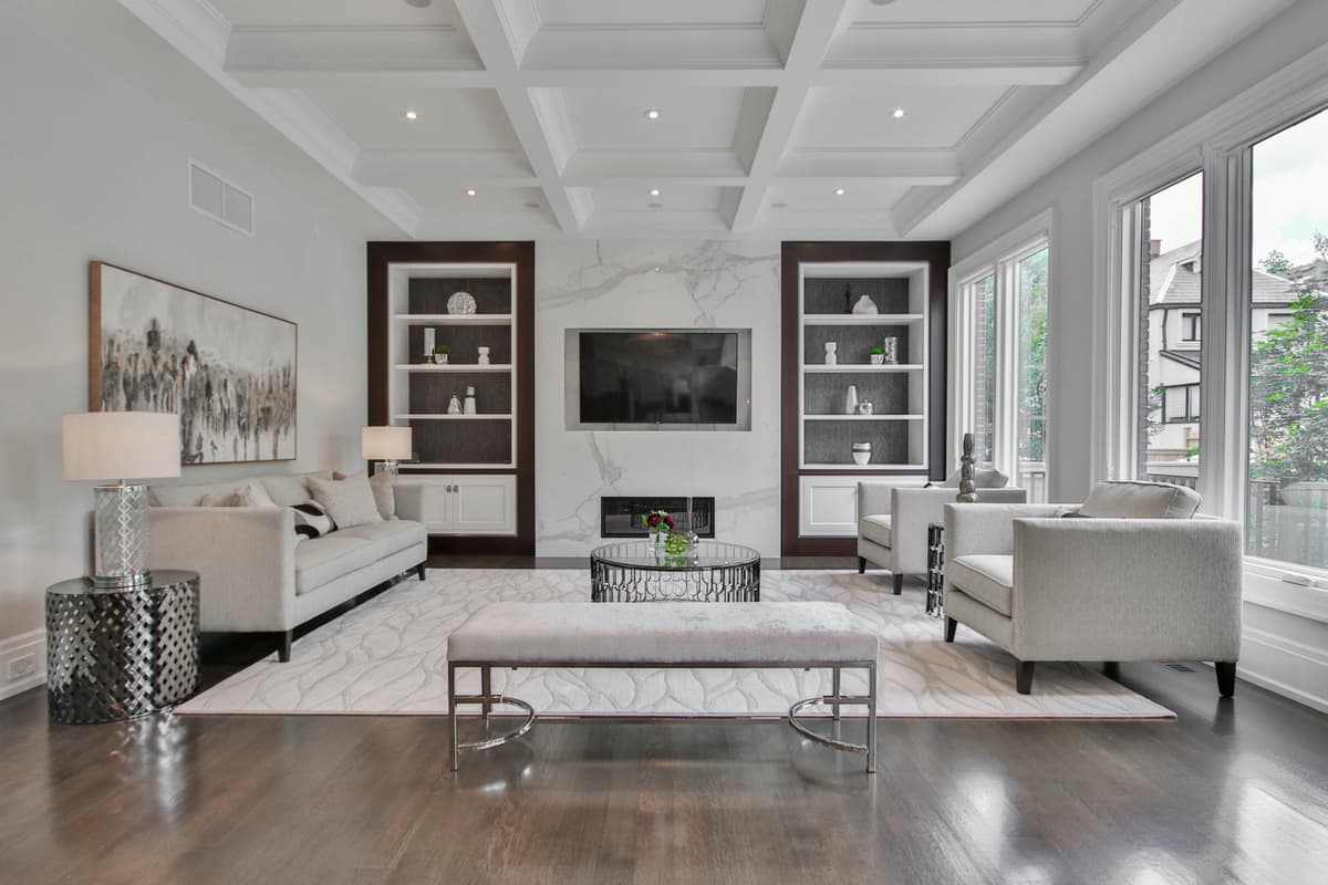 Coffered ceiling and fireplace wall decorated in crisp white